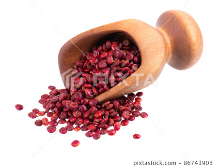 Sumac seeds in wooden scoop, isolated on white background. Whole dry Rhus berry. Sumac seeds in wooden scoop, isolated on white background. Whole dry Rhus berry. 86741903