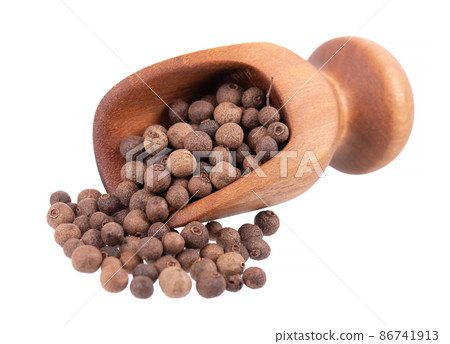 Allspice in wooden scoop, isolated on white background. Jamaican pepper, pimento berry, allspice peppercorns or myrtle pepper. Allspice in wooden scoop, isolated on white background. Jamaican pepper, pimento berry, allspice peppercorns or myrtle pepper. 86741913