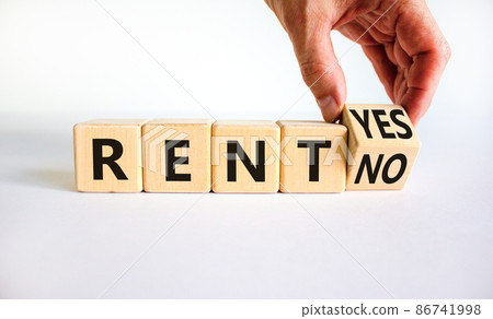 Time to rent symbol. Businessman turns a wooden cube and changes the words rent no to rent yes. Beautiful white table, white background. Business and time to rent concept. Copy space. Time to rent symbol. Businessman turns a wooden cube and changes the words rent no to rent yes. Beautiful white table, white background. Business and time to rent concept. Copy space. 86741998