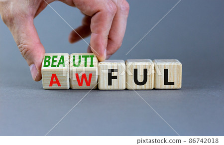 Beautiful or awful symbol. Businessman turns wooden cubes, changes the word Awful to Beautiful. Beautiful grey background, copy space. Business, psychological beautiful or awful concept. Beautiful or awful symbol. Businessman turns wooden cubes, changes the word Awful to Beautiful. Beautiful grey background, copy space. Business, psychological beautiful or awful concept. 86742018