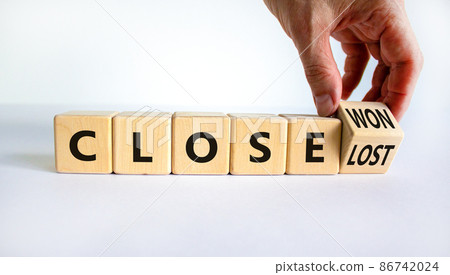 Close won or lost symbol. Businessman turns the wooden cube and changes words Close won to close lost. Beautiful white background, copy space. Business and close won or lost concept. Close won or lost symbol. Businessman turns the wooden cube and changes words Close won to close lost. Beautiful white background, copy space. Business and close won or lost concept. 86742024