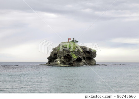 A shrine gate on the island named Okino-Shima with the myth about the love of a white rabbit in Japan. 86743660