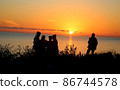 Bright sunset photo with silhouettes of people 86744578