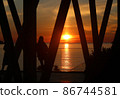 Bright sunset photo with silhouettes of people 86744581