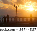 Bright sunset photo with silhouettes of people 86744587