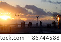 Bright sunset photo with silhouettes of people 86744588