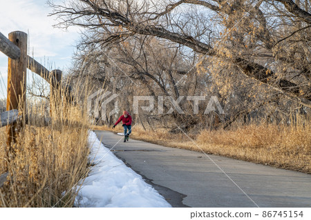 inline skating on a paved bike trail in Colorado inline skating on a paved bike trail in Colorado 86745154