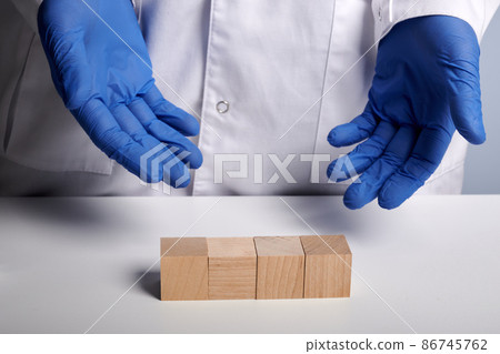 Doctor Shows 4 Wooden Cubes - Photo with Copyspace Doctor Shows 4 Wooden Cubes - Photo with Copyspace 86745762