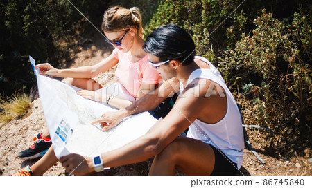 Woman and man studying map in countryside Woman and man studying map in countryside 86745840