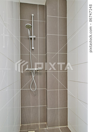 Modern shower stall in a bright bathroom Modern shower stall in a bright bathroom 86747148