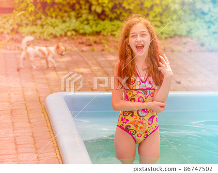 The girl and the pool. A teenager in a positive mood on vacation in a swimsuit. 86747502