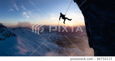 Adult adventurous man rappelling down a rocky cliff. Extreme adventure composite. Adult adventurous man rappelling down a rocky cliff. Extreme adventure composite. 86750115