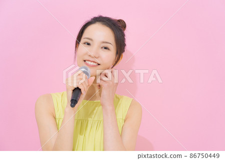 Female in her 20s with a microphone Female in her 20s with a microphone 86750449