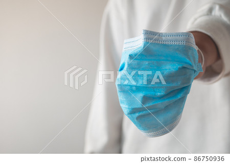 Medical mask in boxing gloves shape. Disease protection such as influenza, flu, Covid. Doctor Fighting Concept. Medical mask in boxing gloves shape. Disease protection such as influenza, flu, Covid. Doctor Fighting Concept. 86750936