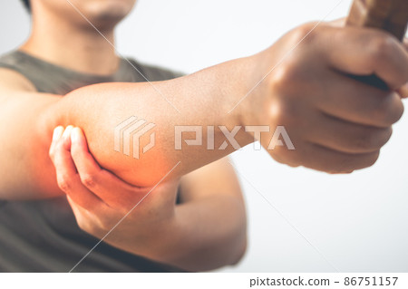 Tennis elbow injury concept. The man holds racket. Symptom area is shown with red color. Healthcare knowledge. Close up shot. 86751157