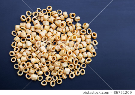 Crispy potato rings on dark background. 86751209