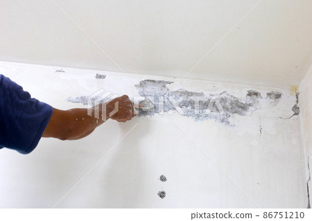 Worker hand scraping old paint Worker hand scraping old paint 86751210