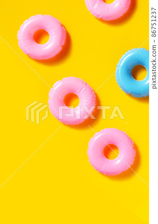 Inflatable rings on yellow background. Summer background concept Inflatable rings on yellow background. Summer background concept 86751237