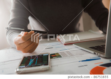 Businesswoman analyze business report graph and finance chart at corporate office. Concept of finance economy, banking business and stock market research. Businesswoman analyze business report graph and finance chart at corporate office. Concept of finance economy, banking business and stock market research. 86751655
