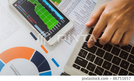 Businesswoman analyze business report graph and finance chart using smartphone and computer laptop at corporate office. Businesswoman analyze business report graph and finance chart using smartphone and computer laptop at corporate office. 86751657
