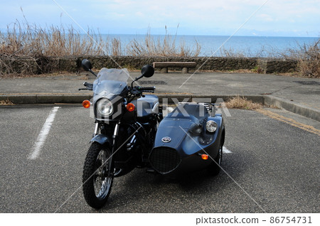 A black sidecar standing in a seaside parking lot A black sidecar standing in a seaside parking lot 86754731