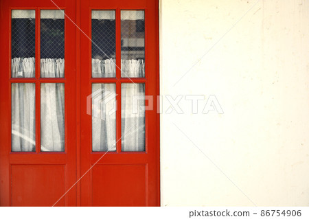 Antique red door and white exterior wall Antique red door and white exterior wall 86754906