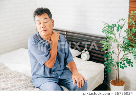 Elderly man (stiff shoulder) getting sick in the bedroom Elderly man (stiff shoulder) getting sick in the bedroom 86756024