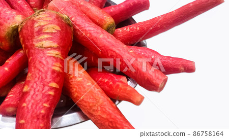 Lots of fresh red and sweet peeled carrots kept in a plate Lots of fresh red and sweet peeled carrots kept in a plate 86758164
