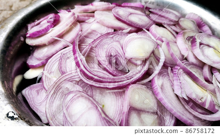 Bunch of sliced organic red onions a plate 86758172