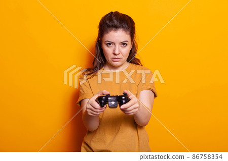 Portrait of woman holding controller in front of camera 86758354