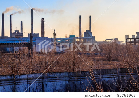 View of old factory with pipes with smoke. Air pollution, environmental damage View of old factory with pipes with smoke. Air pollution, environmental damage 86761965