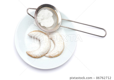 Traditional German or Austrian Vanillekipferl vanilla kipferl cookies on a plate isolated on white background Traditional German or Austrian Vanillekipferl vanilla kipferl cookies on a plate isolated on white background 86762712