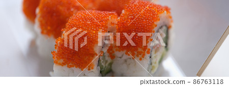 Roll California with cream cheese tobiko caviar closeup. Roll California with cream cheese tobiko caviar closeup. 86763118