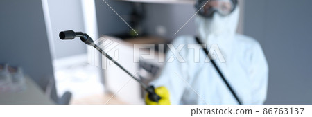 Person in protective suit and mask disinfects kitchen Person in protective suit and mask disinfects kitchen 86763137