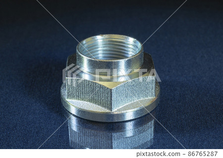 Metal nut with thread on the table with reflection 86765287