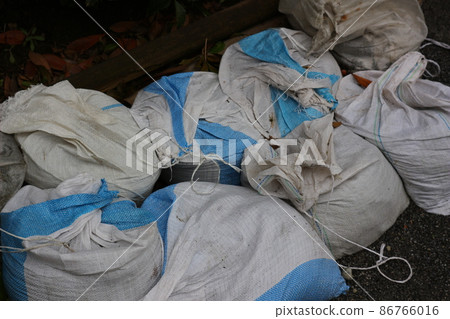 Sandbags for river flood control. Flood measures. Sandbags for river flood control. Flood measures. 86766016