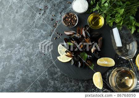 Concept of delicious food with mussels on black smokey table Concept of delicious food with mussels on black smokey table 86768050