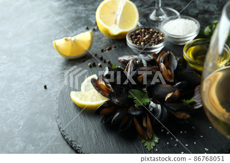 Concept of delicious food with mussels on black smokey table Concept of delicious food with mussels on black smokey table 86768051