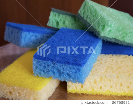 Several sponges of blue, yellow and green colors, a close-up shot. Several sponges of blue, yellow and green colors, a close-up shot. 86768951