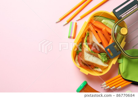 Lunch box with tasty food on pink background 86770684