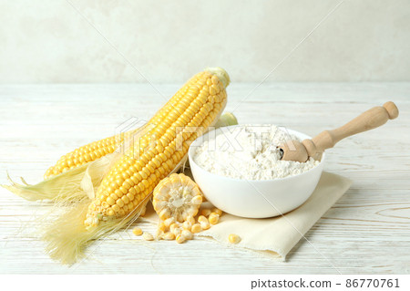 Raw corn and flour on white wooden table Raw corn and flour on white wooden table 86770761
