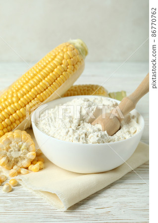 Raw corn and flour on white wooden table Raw corn and flour on white wooden table 86770762