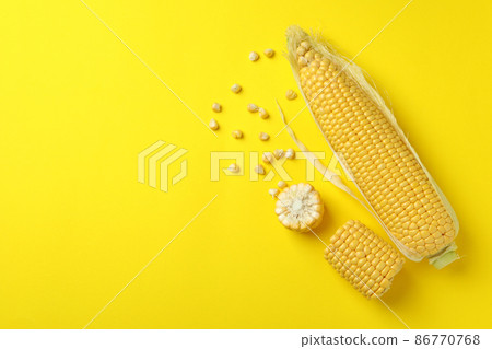 Fresh raw corn on yellow background, top view 86770768
