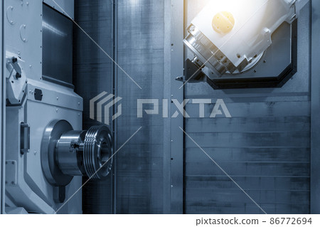 The multi-tasking CNC machine cutting the metal pulley part. The multi-tasking CNC machine cutting the metal pulley part. 86772694