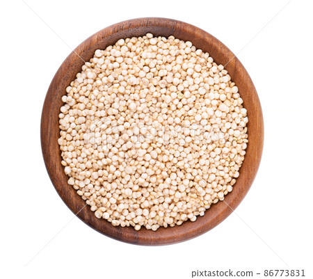 White quinoa seeds in wooden bowl, isolated on white background. Pile of raw kinwa. Top view. White quinoa seeds in wooden bowl, isolated on white background. Pile of raw kinwa. Top view. 86773831