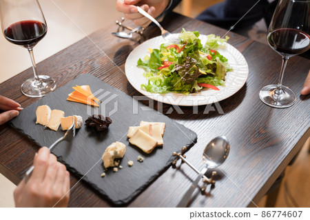 Men and women eating while having a conversation at a restaurant 86774607