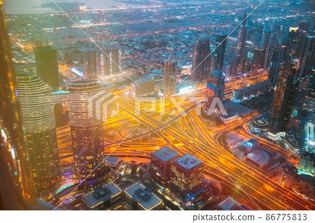 Aerial View Of Evening Night Traffic Of Dubai. City Street Night Illumination Of Residential District In Dubai. Night Scenic View Of Skyscraper In Dubai. cityscape background. Urban background. High Aerial View Of Evening Night Traffic Of Dubai. City Street Night Illumination Of Residential District In Dubai. Night Scenic View Of Skyscraper In Dubai. cityscape background. Urban background. High 86775813
