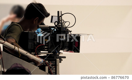 Recording video at studio. Camera records or filming for professional bloggers. Behind the scenes of filming video production. film crew on the set in film studio. Backstage video production recording Recording video at studio. Camera records or filming for professional bloggers. Behind the scenes of filming video production. film crew on the set in film studio. Backstage video production recording 86776670