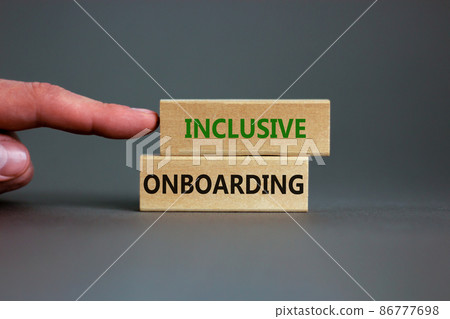 Inclusive onboarding symbol. Wooden blocks with words Inclusive onboarding on beautiful grey background. Businessman hand. Business, HR and inclusive onboarding concept. Copy space. 86777698