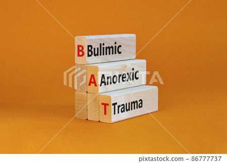 BAT bulimic anorexic trauma symbol. Concept words BAT bulimic anorexic trauma on blocks on a beautiful orange table, orange background. Medical and BAT bulimic anorexic trauma concept. Copy space. BAT bulimic anorexic trauma symbol. Concept words BAT bulimic anorexic trauma on blocks on a beautiful orange table, orange background. Medical and BAT bulimic anorexic trauma concept. Copy space. 86777737